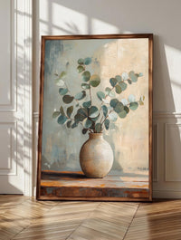 Eucalyptus wall art: silvery eucalyptus leaves resting in a handmade ceramic vase