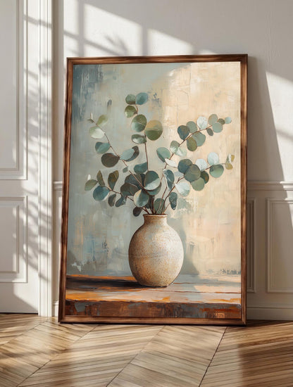 Eucalyptus wall art: silvery eucalyptus leaves resting in a handmade ceramic vase